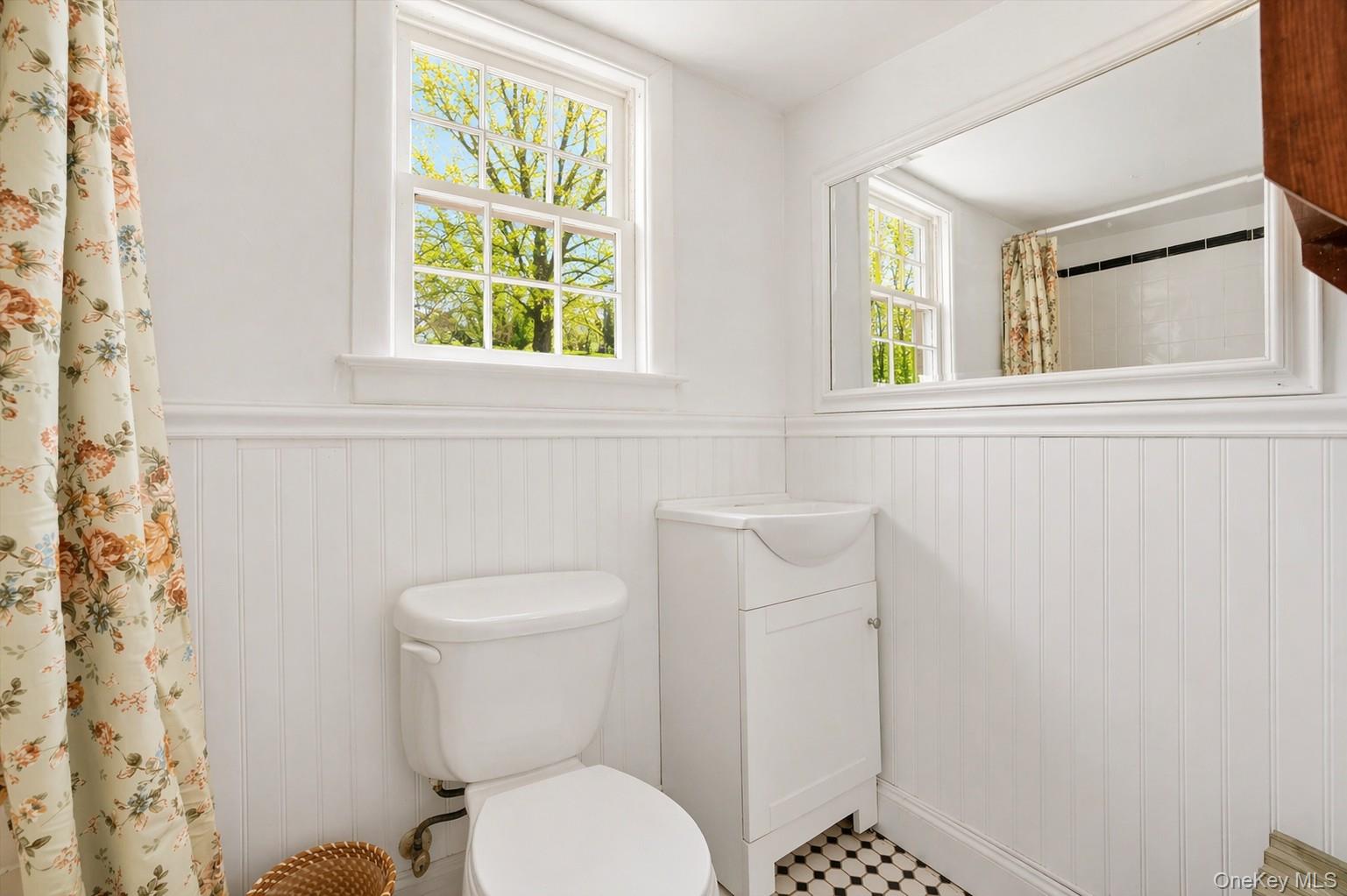 1835 Jacob Road Cortlandt Manor, NY 10567 - Photo 15 of 27 a white toilet sitting next to a window in a bathroom