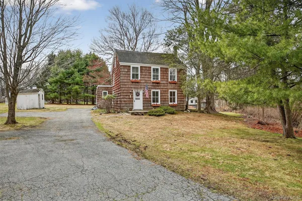 a view of a livingroom with furniture and staircase