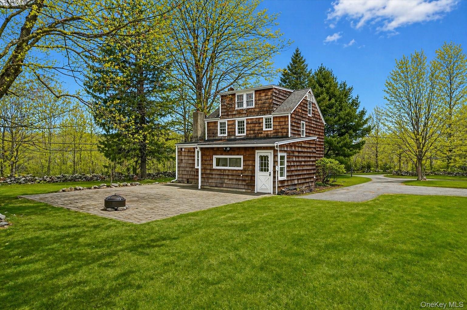 1835 Jacob Road Cortlandt Manor, NY 10567 - Photo 21 of 27 a front view of a house with a yard