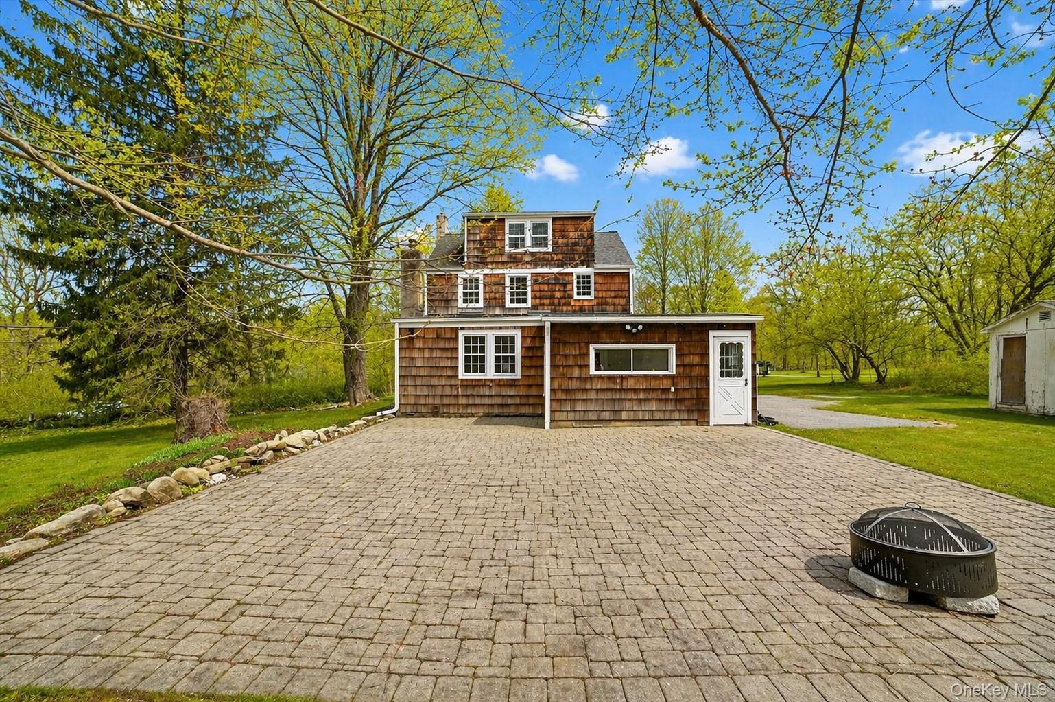 1835 Jacob Road Cortlandt Manor, NY 10567 - Photo 22 of 27 a front view of a house with a yard
