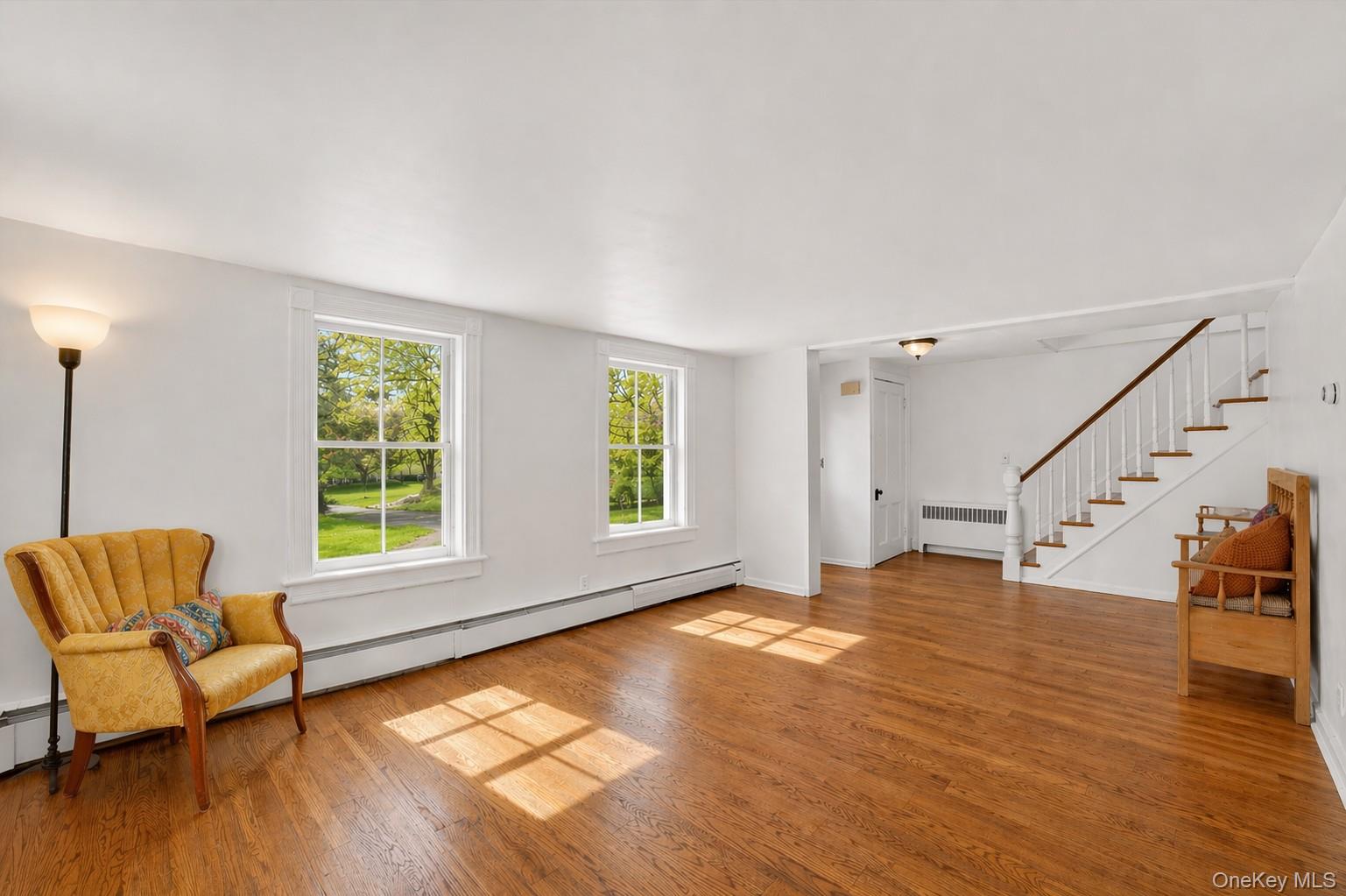 1835 Jacob Road Cortlandt Manor, NY 10567 - Photo 4 of 27 a view of an empty room with window and wooden floor