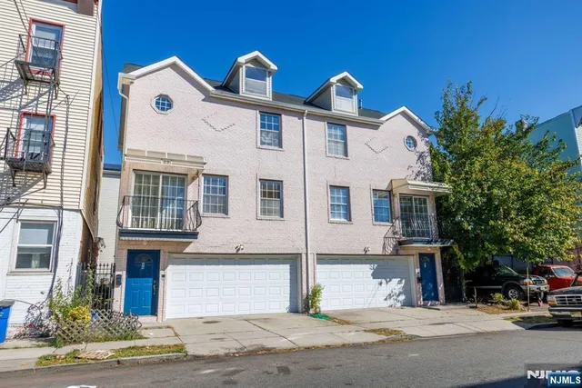 a view of multiple houses with a street