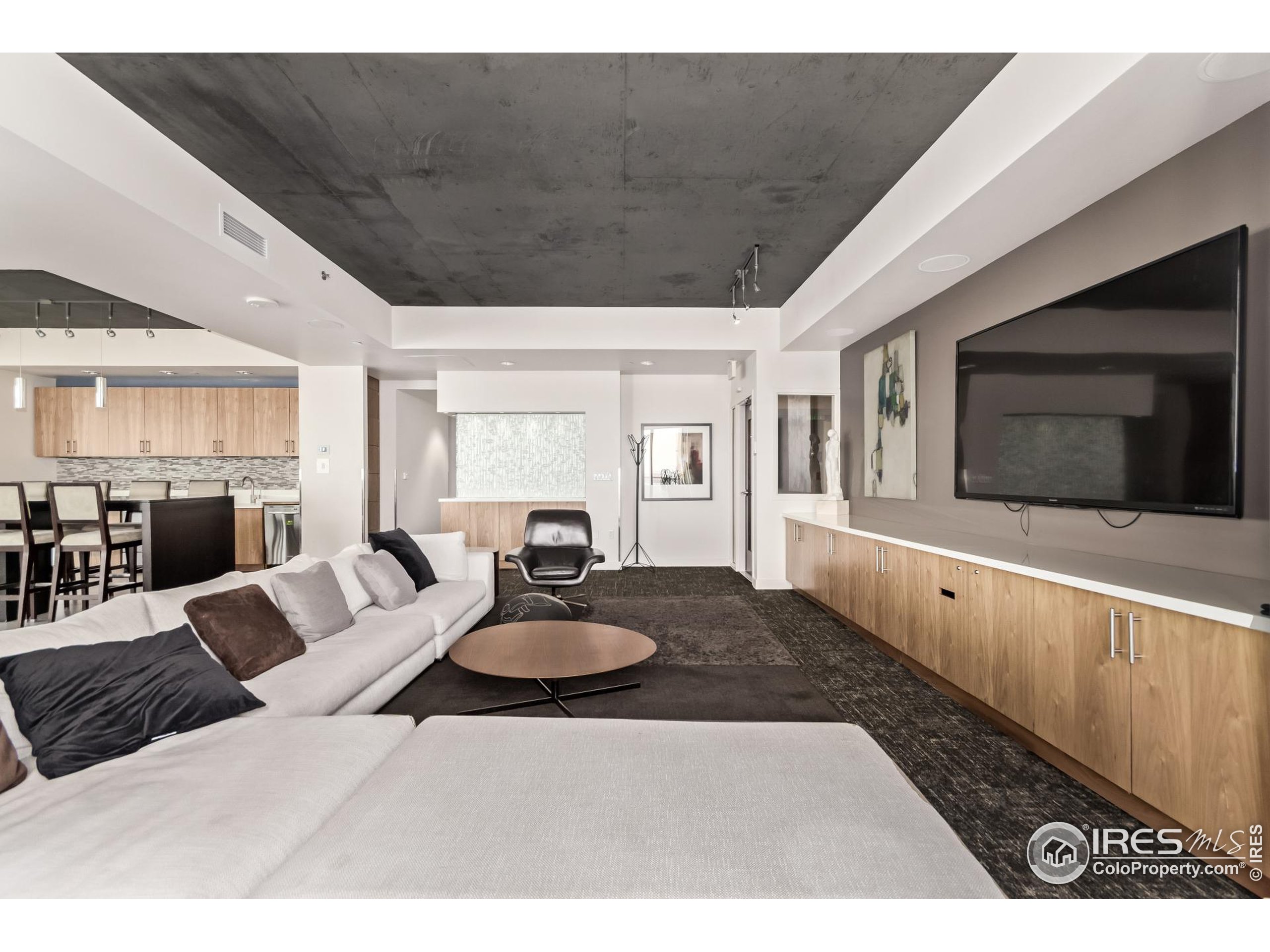 891 14th Street, Unit 3904 Denver, CO 80202 - Photo 16 of 39 a living room with furniture a flat screen tv and kitchen view