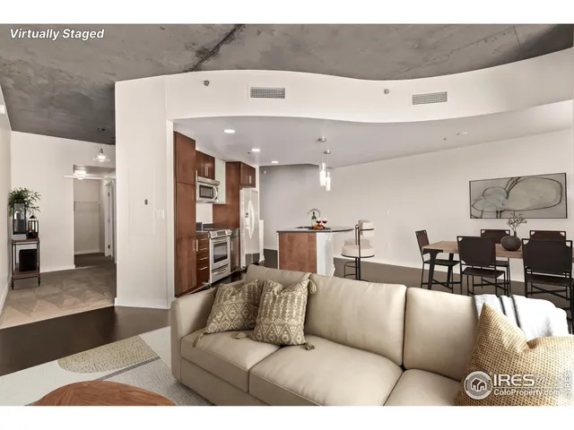 a living room with furniture and kitchen view