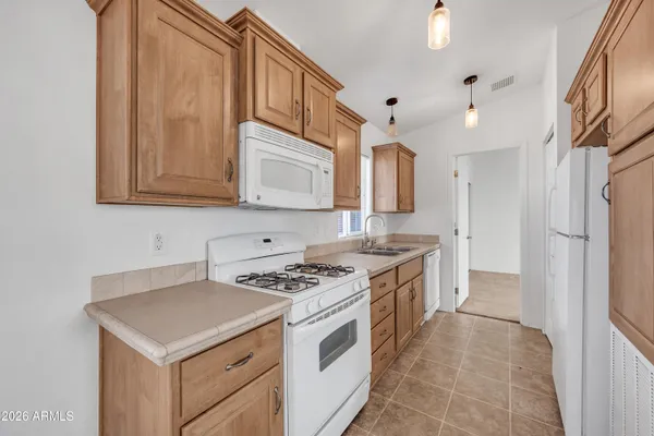 a kitchen with stainless steel appliances granite countertop a refrigerator and a stove
