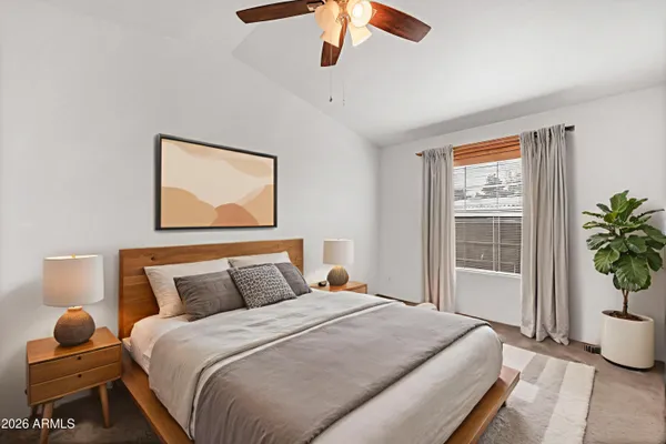 a bedroom with bed and window