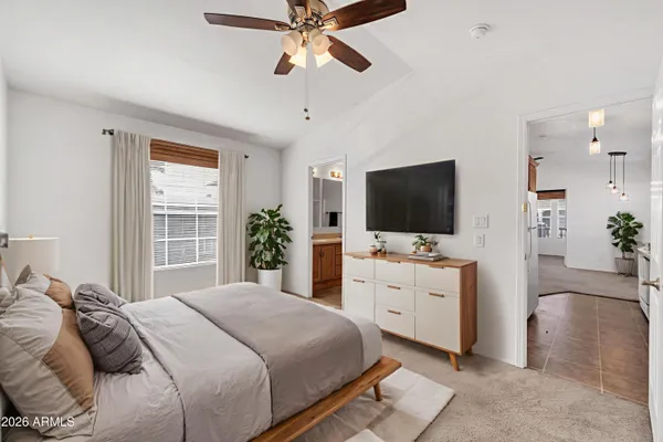 a bedroom with a flat screen television and a bed