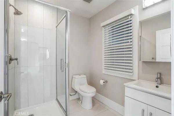 a bathroom with a toilet sink a shower and a mirror