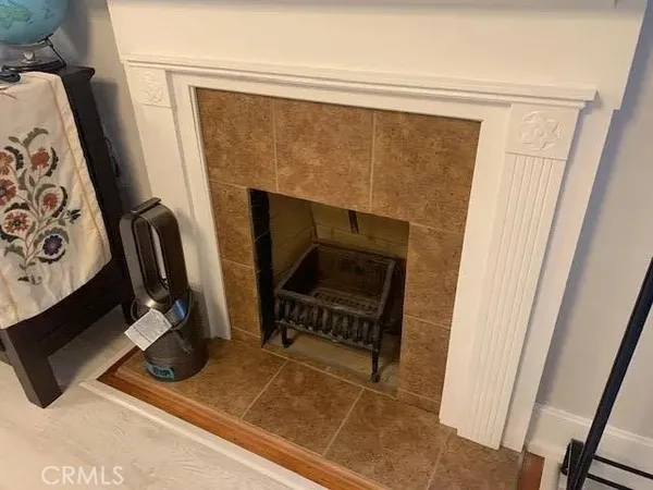 a living room with a fireplace and a window