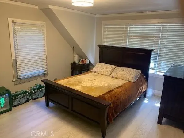a bed sitting in a bedroom next to a window