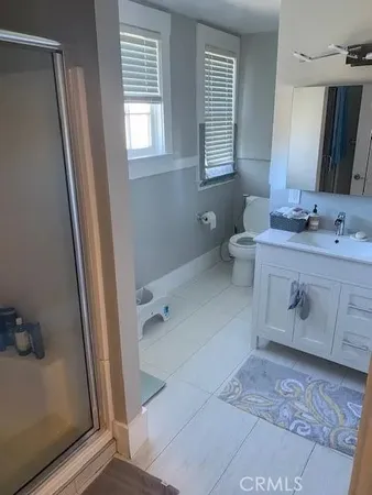 a bathroom with a sink a toilet and mirror