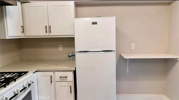 a white refrigerator freezer sitting inside of a kitchen