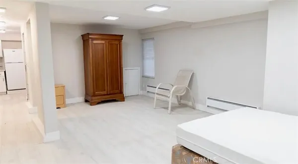 a bedroom with a bed and a painting on the wall