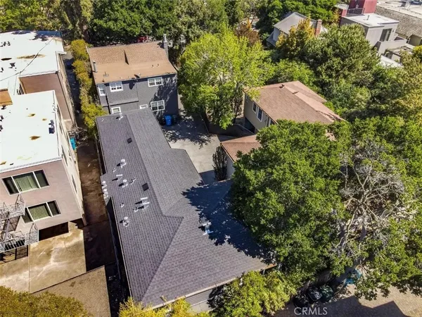 an aerial view of a house with a yard