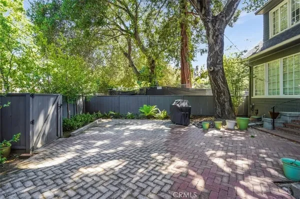 a backyard of a house with table and chairs