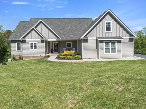 a front view of house with yard and green space