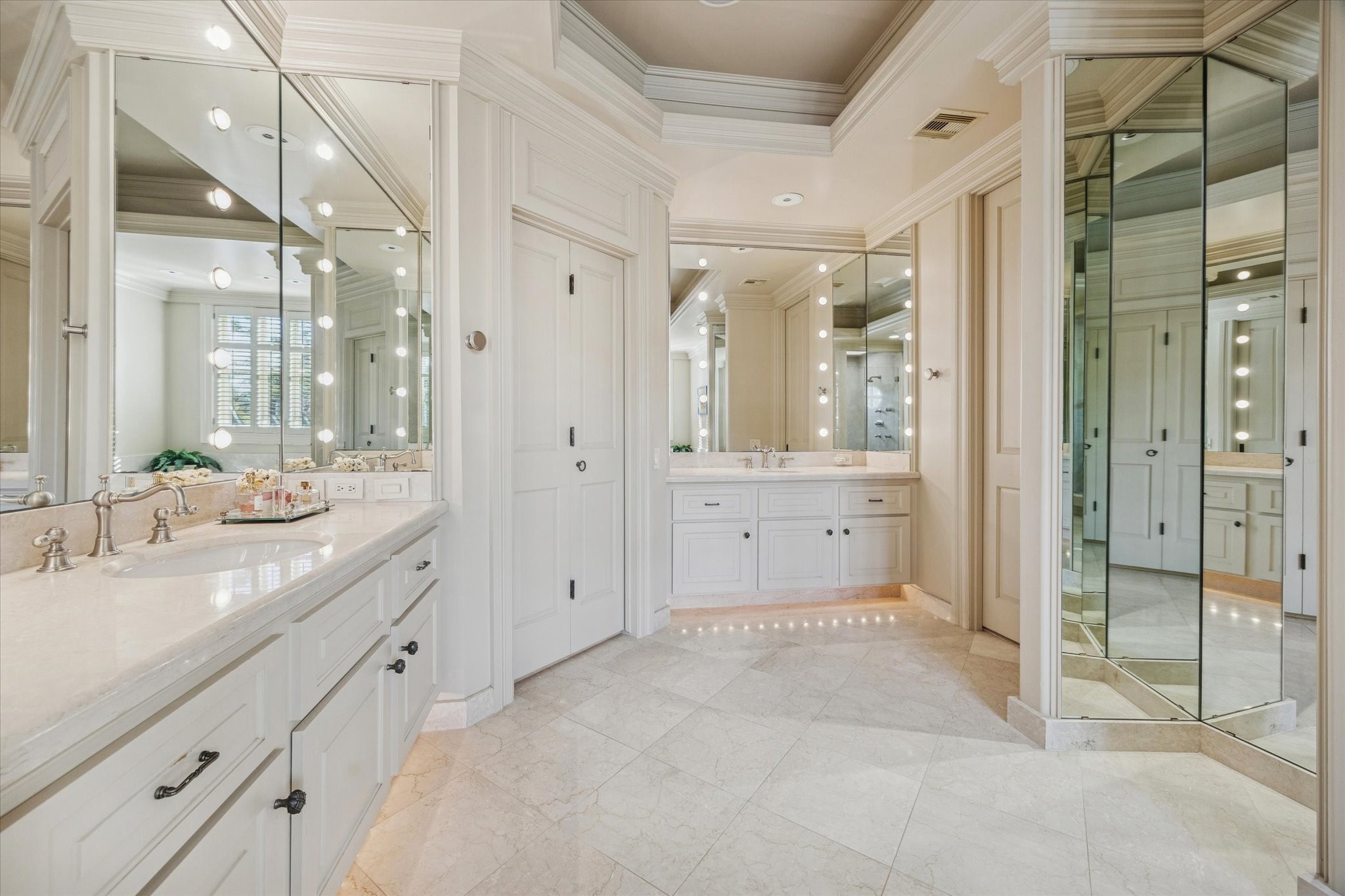 3715 Garnet Street Houston, TX 77005 - Photo 27 of 50 Dual vanities and lighted mirrors in the lavish primary bathroom create depth and reflection.