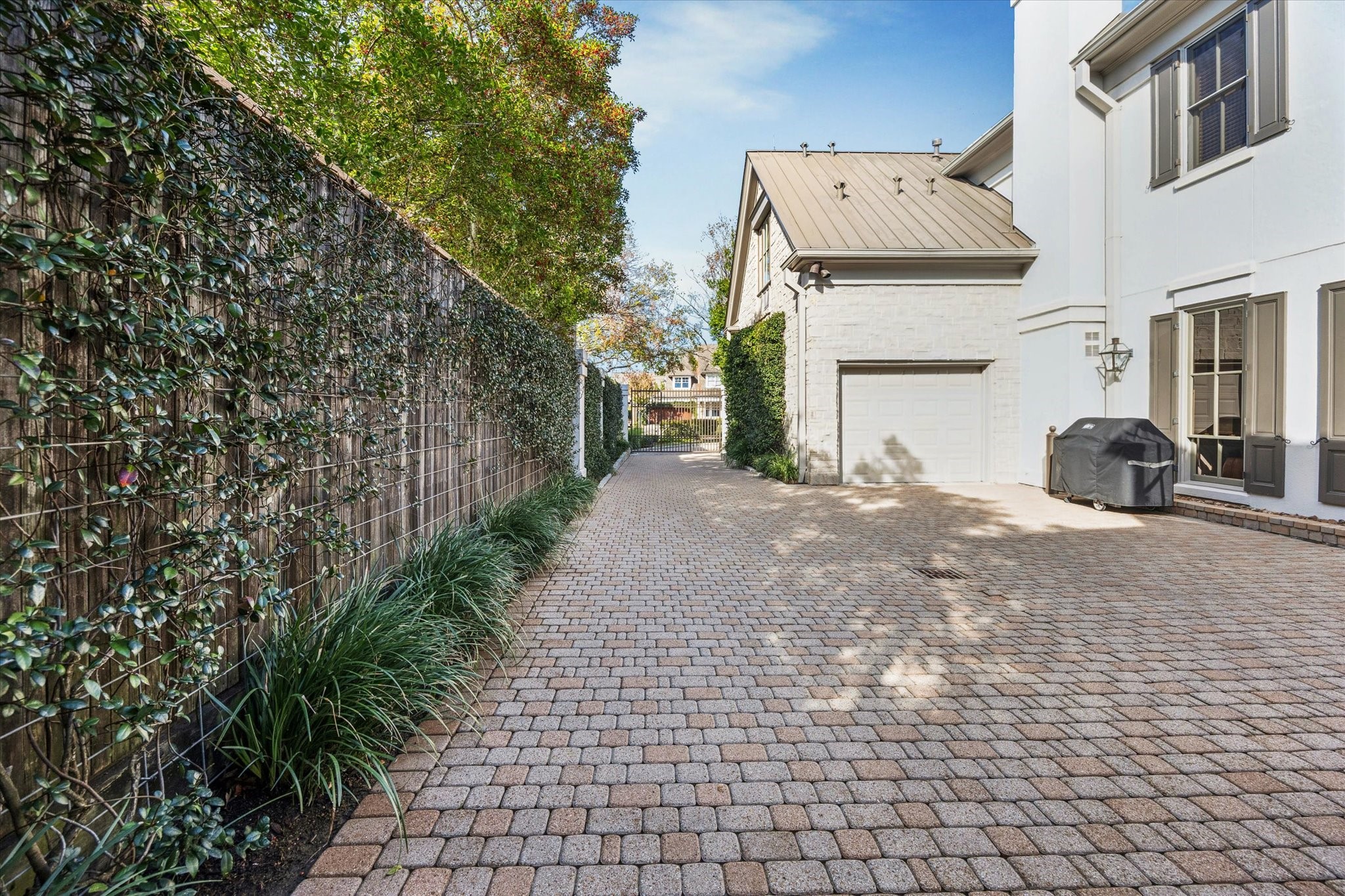 3715 Garnet Street Houston, TX 77005 - Photo 41 of 50 Cobblestone driveway and pavers with automatic gate leads to a forecourt with the 2 car garage and a separate one car garage.