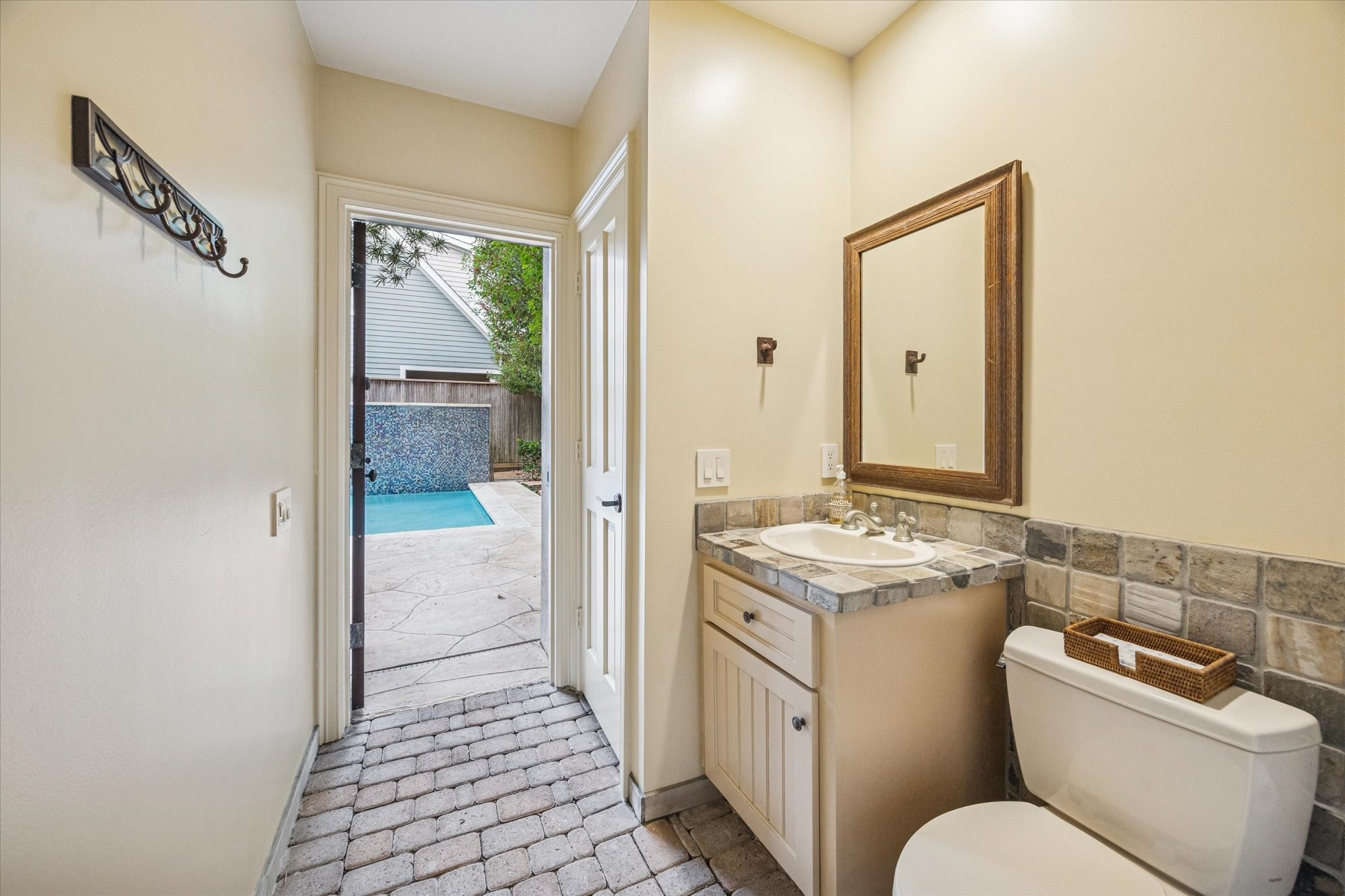 3715 Garnet Street Houston, TX 77005 - Photo 42 of 50 Pool bath with stacked washer and dryer opens to garage and backyard.