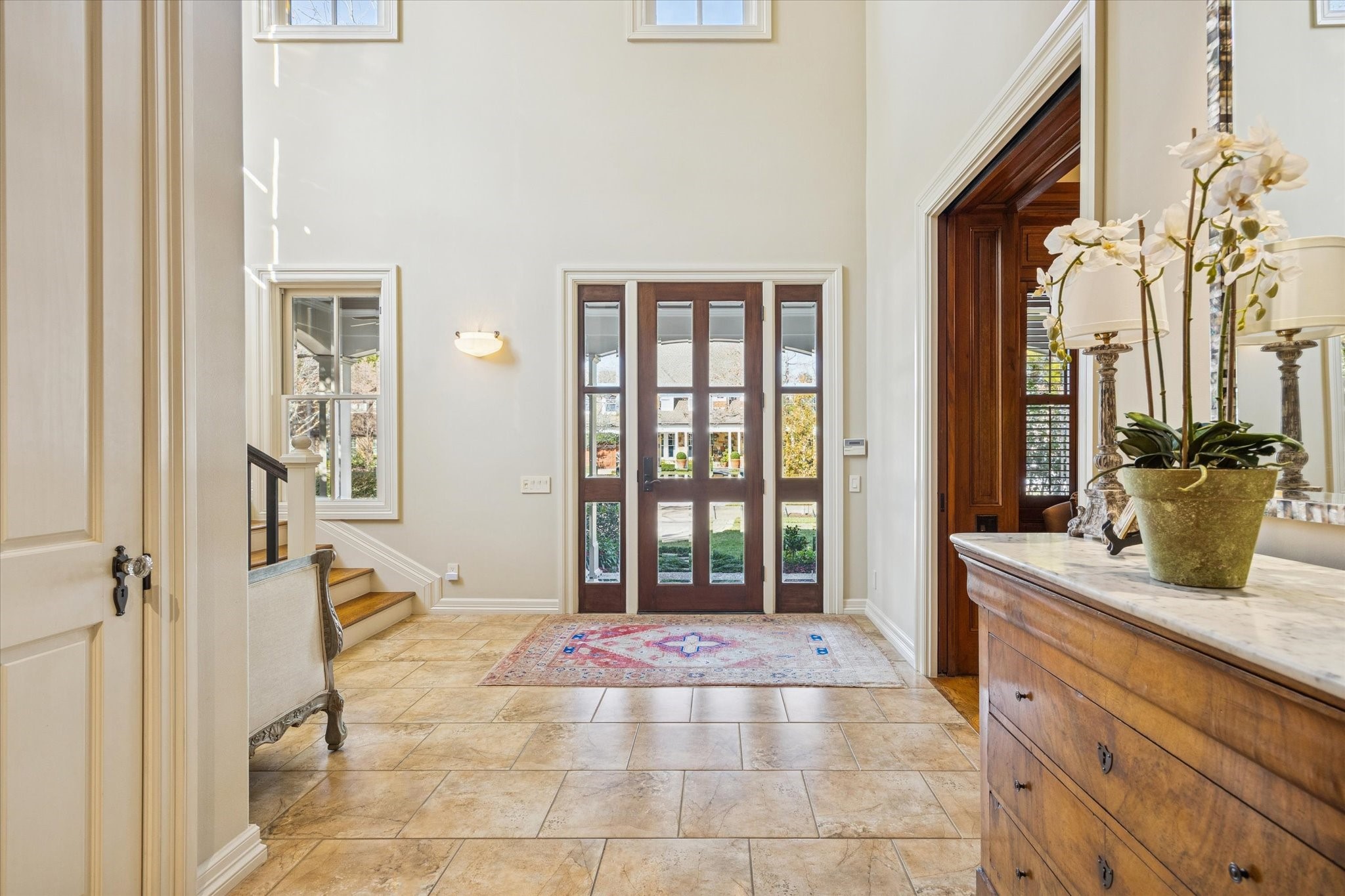 3715 Garnet Street Houston, TX 77005 - Photo 6 of 50 Bright and welcoming foyer with high ceilings and a large wooden front door featuring glass panels. Natural light floods in, creating an inviting atmosphere.
