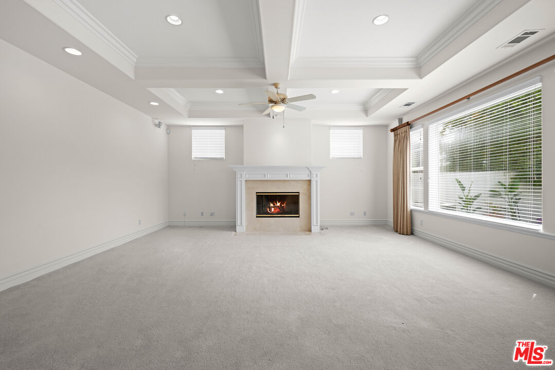 1756 Ruhland Avenue Manhattan Beach, CA 90266 - Photo 12 of 75 an empty room with windows fireplace and a ceiling fan