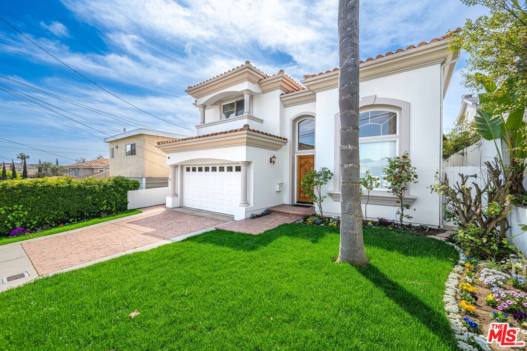 1756 Ruhland Avenue Manhattan Beach, CA 90266 - Photo 2 of 75 a view of a white house with a big yard and potted plants
