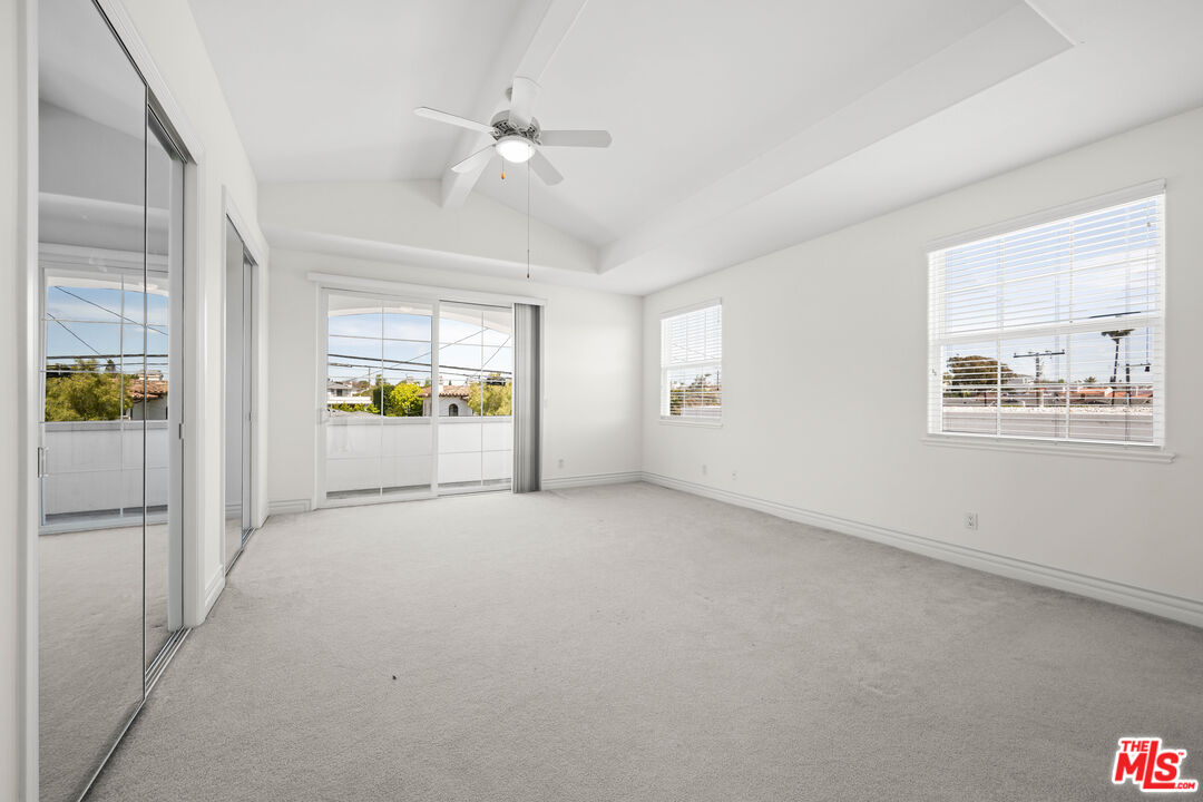 1756 Ruhland Avenue Manhattan Beach, CA 90266 - Photo 21 of 75 an empty room with windows and chandelier fan
