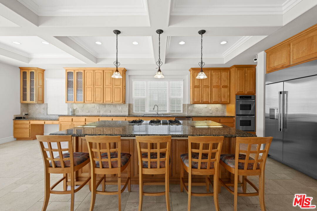 1756 Ruhland Avenue Manhattan Beach, CA 90266 - Photo 30 of 75 a kitchen with a dining table chairs cabinets and stainless steel appliances