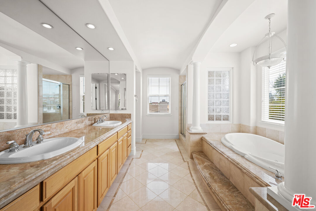1756 Ruhland Avenue Manhattan Beach, CA 90266 - Photo 44 of 75 a spacious bathroom with a granite countertop tub sink and mirror