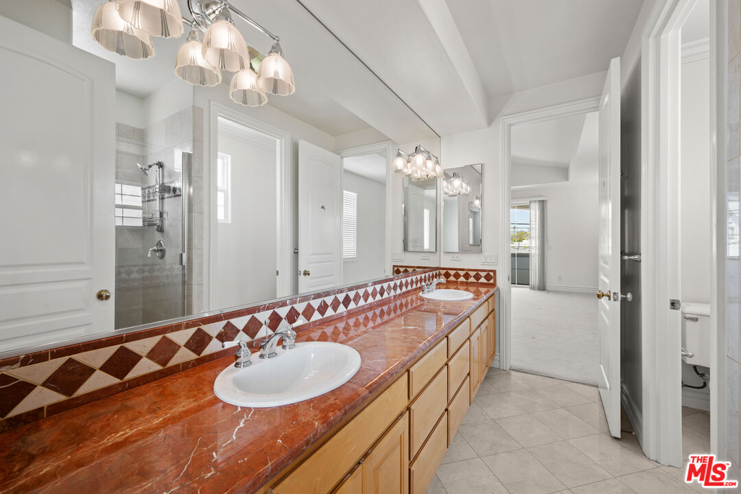 1756 Ruhland Avenue Manhattan Beach, CA 90266 - Photo 53 of 75 a bathroom with a sink a large mirror and a shower