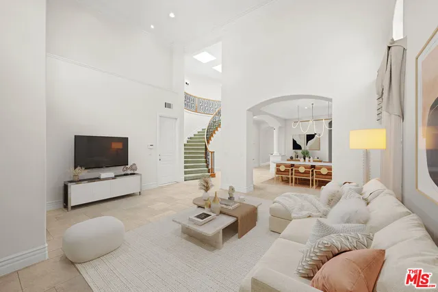 an empty room with windows fireplace and a ceiling fan