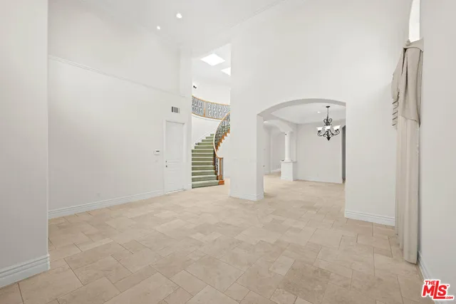 a spacious bedroom with a large bed and a fireplace