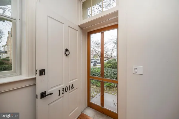 a view of an entryway with wooden floor