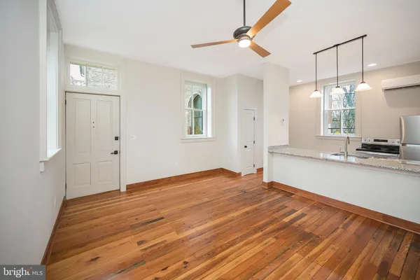 a view of a kitchen and wooden floor