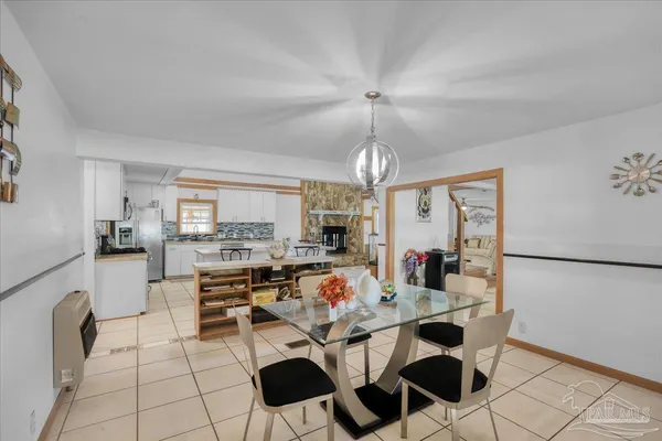 a kitchen with white cabinets and refrigerator