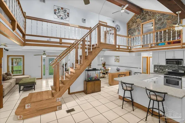 a bedroom with a bed and a large mirror