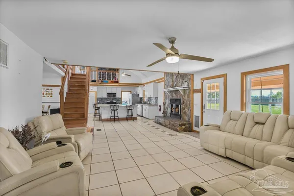 a living room with furniture and a fireplace
