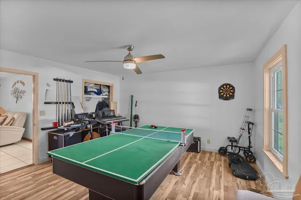 a living room with a large window and a rug