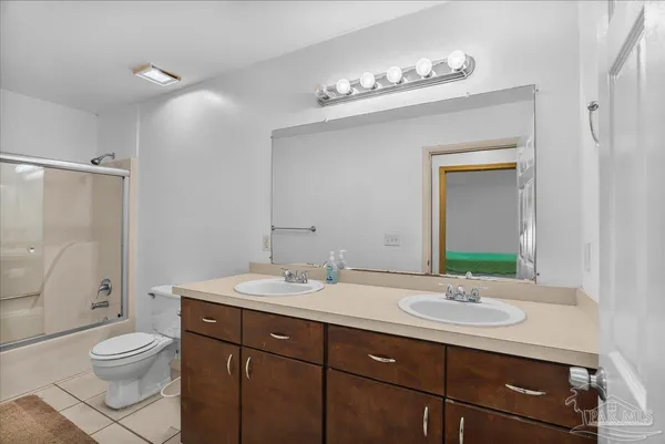 a bathroom with a sink double vanity and a shower