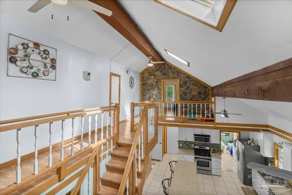 a view of a chair and tables in the balcony