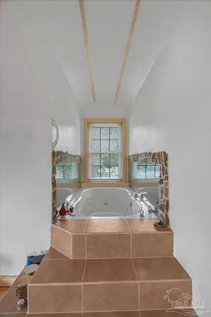 a view of a big house with a big yard and large trees