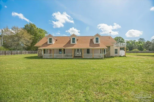 a front view of a house with a garden and a yard