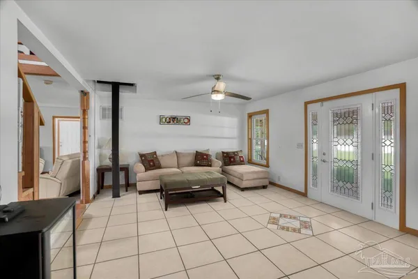 a living room with furniture a chandelier and kitchen view