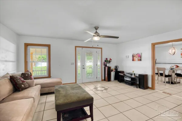 a kitchen with stainless steel appliances kitchen island granite countertop table chairs and a refrigerator