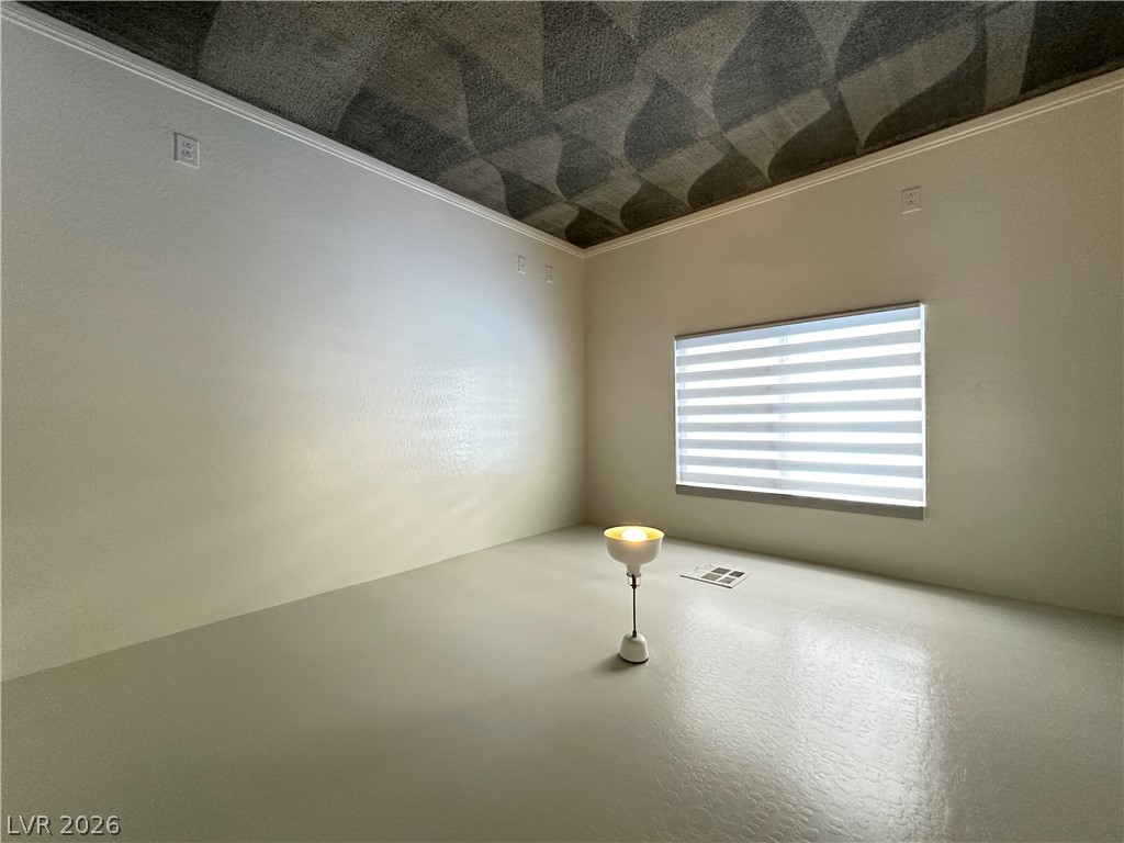 6784 Pivot Point Street Las Vegas, NV 89148 - Photo 20 of 27 A well-lit, neutral room with a patterned ceiling awaits your personalization.