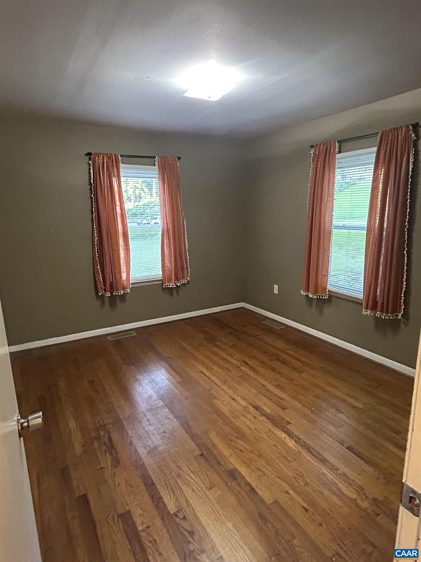 1863 River Road Faber, VA 22938 - Photo 17 of 44 an empty room with wooden floor and windows