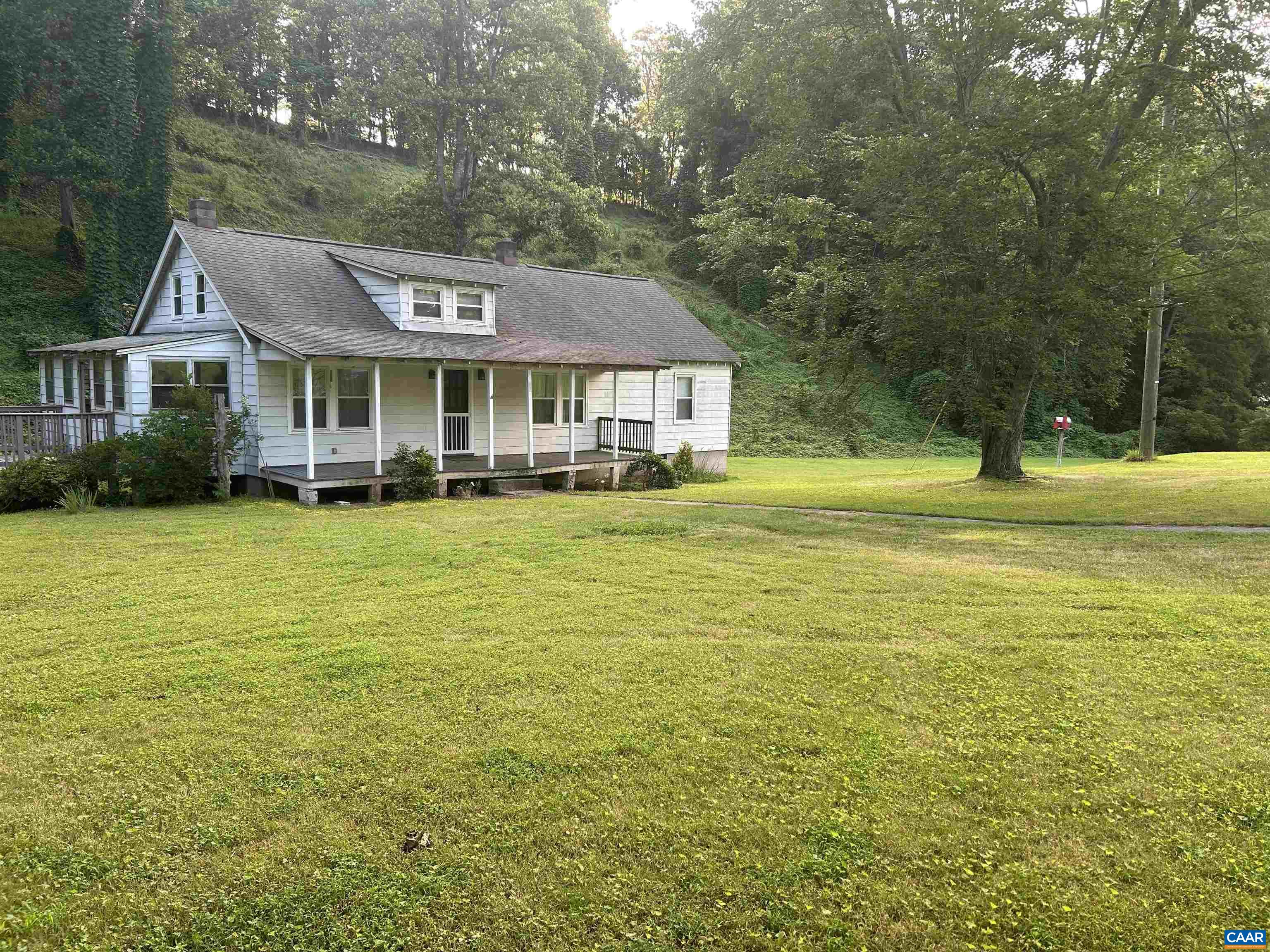 1863 River Road Faber, VA 22938 - Photo 2 of 44 a front view of a house with a garden