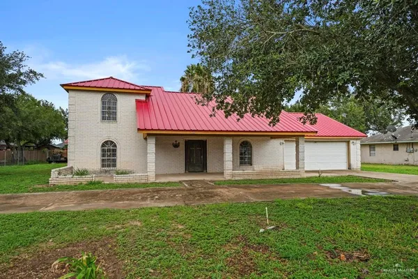 a front view of a house with a yard