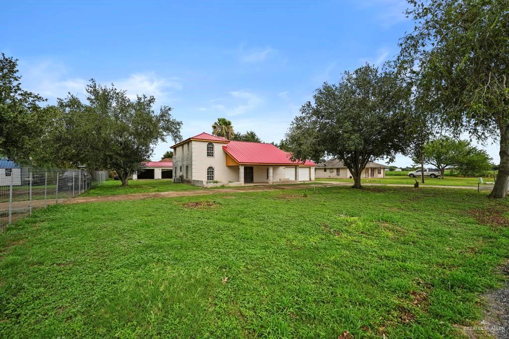 7708 Alberto Road Edinburg, TX 78542 - Photo 3 of 17 a yellow and red house with a garden