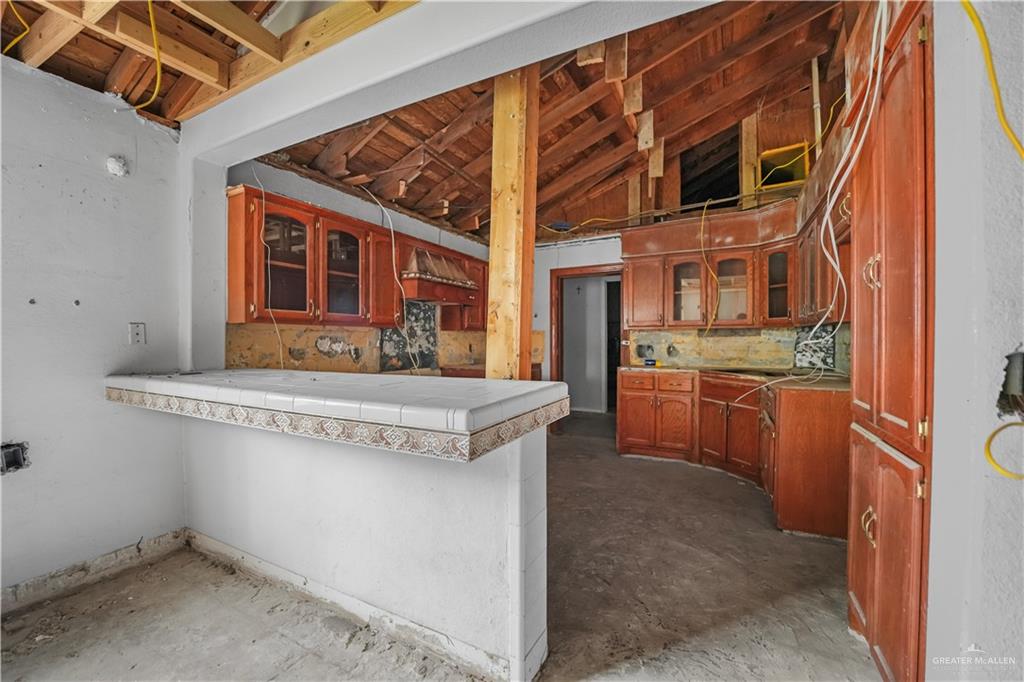 7708 Alberto Road Edinburg, TX 78542 - Photo 8 of 17 a kitchen with stainless steel appliances granite countertop a stove and a sink